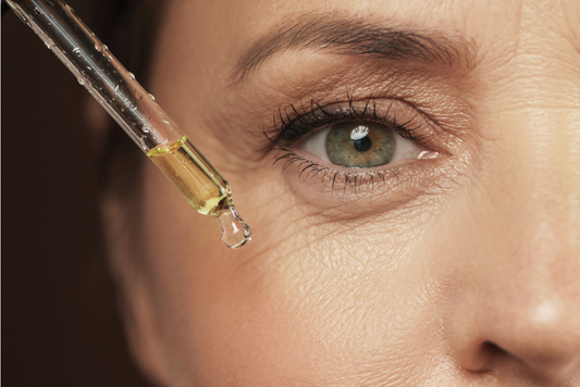 “Woman over 60 applying Vitamin C serum to glowing skin”